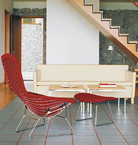 Bertoia Bird high-back chair and ottoman with florence knoll coffee tables in the background